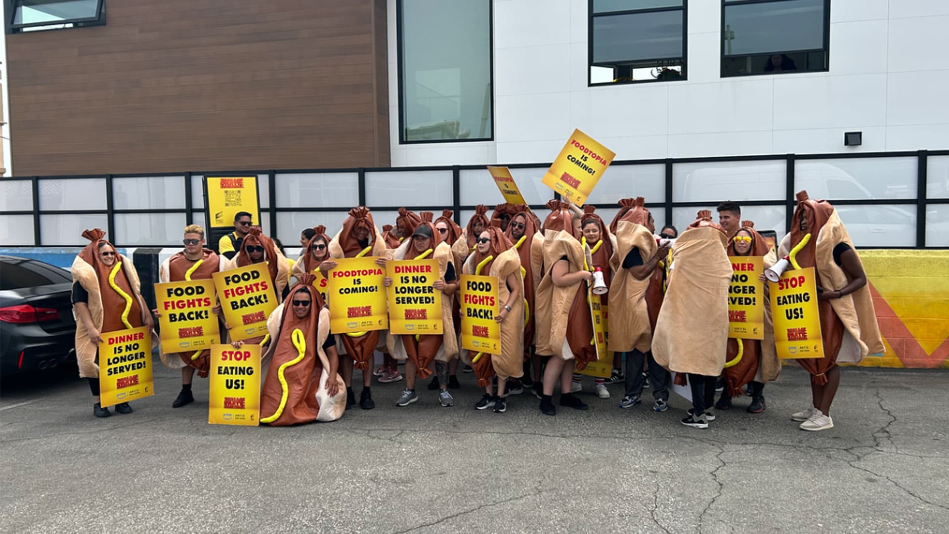 Activation team posing in costume against a photo wall