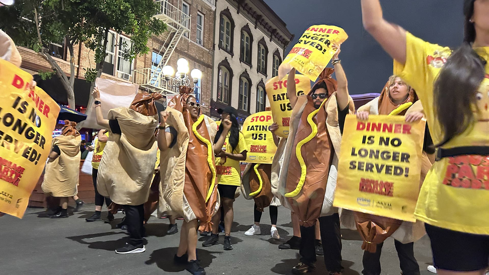 Night march with glowing yellow protest signs